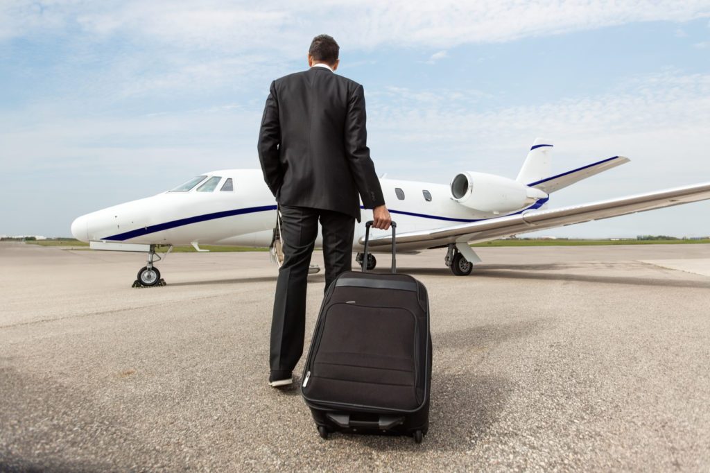 Wealthy man boarding private jet