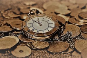 pocket watch on top of money