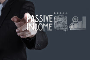 Business Man pointing to passive income and graph