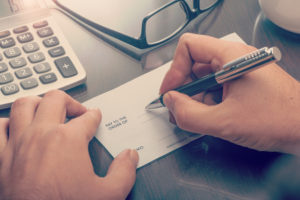 writing check on desk